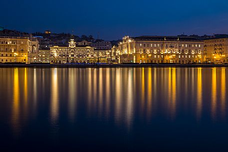 Buildings and Government palace on the waterfront of Trieste at night at Christmas time, Italy
