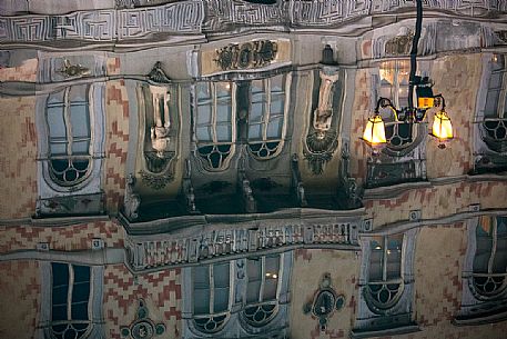 Old palace reflected on the Canal Grande or Ponterosso in Trieste city at night, Italy