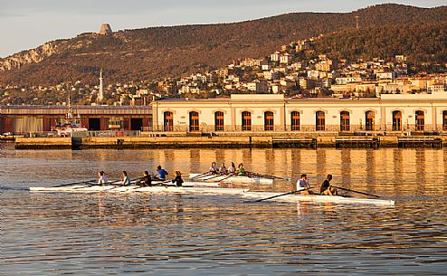 Boating along the waterfront of Trieste at sunset, Italy Boating along the waterfront of Trieste at sunset, Italy