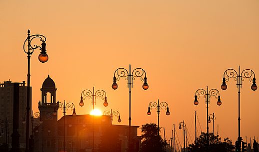 The streetlamps along the waterfront of Trieste at sunset, Italy