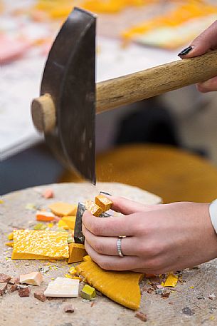 Preparing the colored mosaic tiles and hammer in the oldest Mosaic School of Friuli, Spilimbergo, Italy