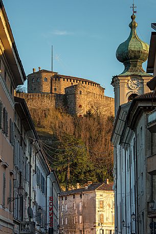 Gorizia Castle at sunset, on the right the dome of the church of Saint Ignazio, Friuli, Italy