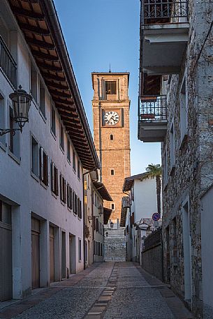The sixteenth-century bell tower of San Daniele del Friuli lit at sunset, Italy
