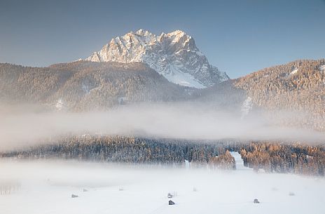 The barns of Sesto under the morning fog and the Cima di Sesto on background, Sesto, dolomites, Italy