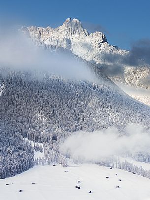 The barns of Sesto from above with the Tre Scarperi Mount on background, Pusteria valley, dolomites The barns of Sesto from above with the Tre Scarperi Mount on background, Pusteria valley, dolomites