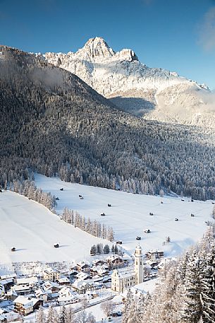 Sesto village from above and the Tre Scarpieri Mount on background in winter time, Pusteria valley, Italy