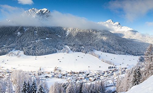 Sesto village and the Sesto dolomites in the background after a snowfall, Pusteria valley, Italy