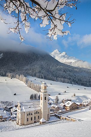 The parish church of Sesto after an intensive snowfall, Pusteria valley, Italy
