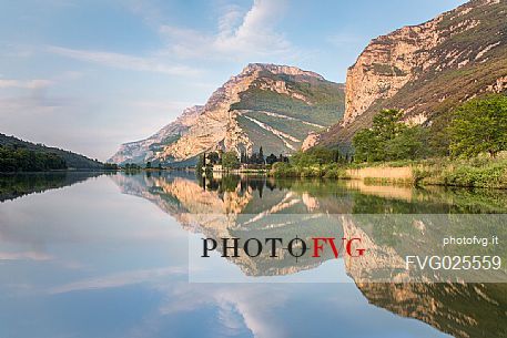 The Toblino Castle seen from the north shore reflects on the waters of the homonymous lake, Valley of Lakes, Trentino, Italy