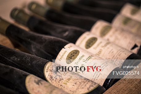Aged bottles of Vino Santo of the distillery of Francesco Poli in Santa Massenza, Valley of Lakes,Trentino, Italy Aged bottles of Vino Santo of the distillery of Francesco Poli in Santa Massenza, Valley of Lakes,Trentino, Italy