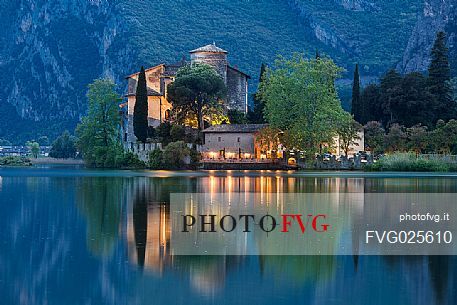 The Toblino Castle reflects on the waters of the homonymous lake at twilight, Valley of Lakes, Valle dei Laghi, Trentino, Italy