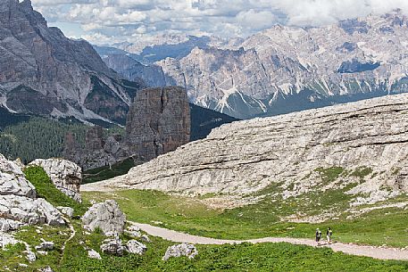 Two hikers along the path from the Averau hut to the Cinque Torri, Dolomites, Cortina D'Ampezzo, Italy