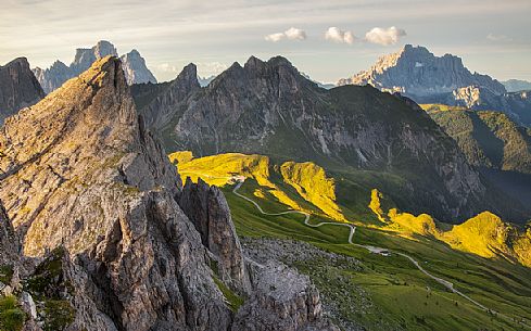 Panoramic view of the Giau Pass, in the background the Pelmo and Civetta Mount illuminated by the early morning lights, Dolomites, Cortina D'Ampezzo, Italy