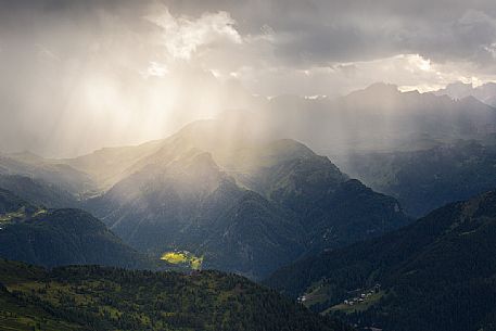 Light rays filter through a cloud in a thunderstorm illuminating the valley in front of the Nuvolau refuge, Dolomites, Cortina D'Ampezzo, Italy Light rays filter through a cloud in a thunderstorm illuminating the valley in front of the Nuvolau refuge, Dolomites, Cortina D'Ampezzo, Italy