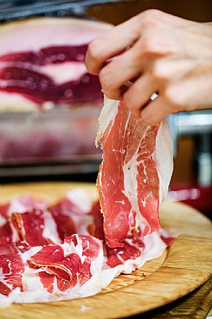 Freshly sliced am cutting board of the historic ham company D'Osvaldo in Cormons, Friuli Venezia Giulia, Italy