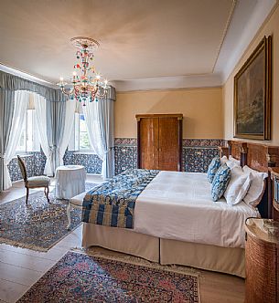 The elegant De Luxe double bedroom of Castello di Spessa castle furnished with original and restored furniture from the end of the 1700s and 800s, Capriva del Friuli, Friuli Venezia Giulia, italy