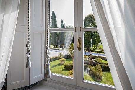 Window overlooking the park of the Castle of Spessa castle from the double bedroom De Luxe, Capriva del Friuli, Friuli Venezia Giulia, italy