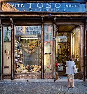 The exterior facade of the historic Toso grocery store, dating back to 1906 with marine sponges, vintage billboards and an old diving equipment featured in the showcase, Trieste, Friuli Venezia Giulia, Italy