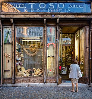 The exterior facade of the historic Toso grocery store, dating back to 1906 with marine sponges, vintage billboards and an old diving equipment featured in the showcase, Trieste, Friuli Venezia Giulia, Italy The exterior facade of the historic Toso grocery store, dating back to 1906 with marine sponges, vintage billboards and an old diving equipment featured in the showcase, Trieste, Friuli Venezia Giulia, Italy