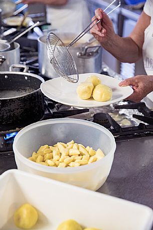 Preparation of plum dumplings, typical dish of Friuli Venezia Giulia's culinary tradition at the Osteria Sardoc in Trieste, Friuli Venezia Giulia, Italy Preparation of plum dumplings, typical dish of Friuli Venezia Giulia's culinary tradition at the Osteria Sardoc in Trieste, Friuli Venezia Giulia, Italy
