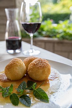 Plum dumplings, typical dish of Friuli Venezia Giulia's culinary tradition at the Osteria Sardoc in Trieste, Friuli Venezia Giulia, Italy Plum dumplings, typical dish of Friuli Venezia Giulia's culinary tradition at the Osteria Sardoc in Trieste, Friuli Venezia Giulia, Italy