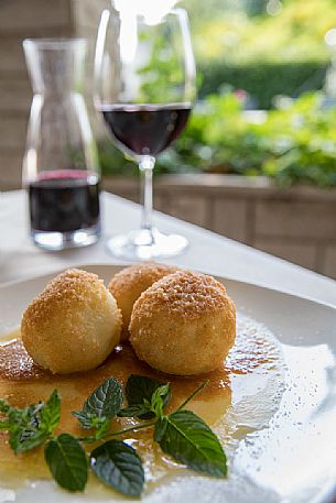 Plum dumplings, typical dish of Friuli Venezia Giulia's culinary tradition at the Osteria Sardoc in Trieste, Friuli Venezia Giulia, Italy