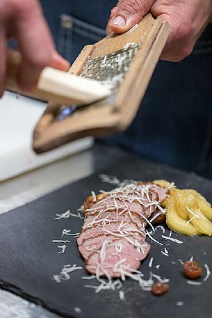 Chef Alessandro Gavagna finishes one of the dishes served at the starred restaurant La Subida Trattoria al Cacciatore in Cormons, Friuli Venezia Giulia, Italy