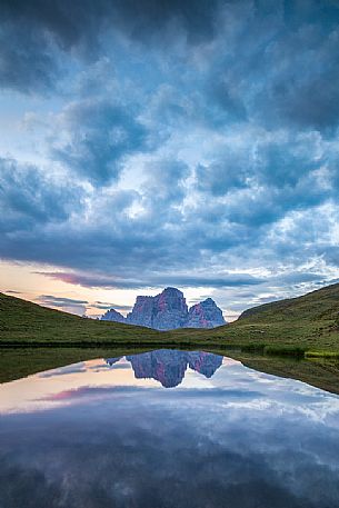 Pelmo mount reflected on Baste lake at twilight, Mondeval, Dolomites, Italy