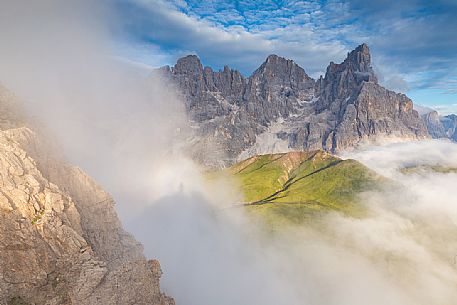 The northern chain of the Pale di San Martino over a cloud of clouds photographed from the top of the path of Cristo Pensante, Dolomites, San Martino di Castrozza, Italy