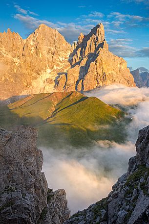 The northern chain of the Pale di San Martino with the Cimon della Pala over a cloud of clouds photographed from the top of the path of Cristo Pensante, Dolomites, San Martino di Castrozza, Italy