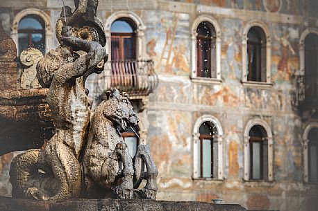 The fountain of Nettuno and the frescoes on the Cazuffi-Rella houses in Duomo square, Trento, Trentino Alto Adige, Italy