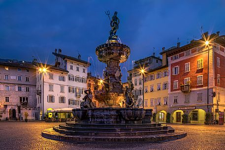 The fountain of Nettuno in Duomo square illuminated by night time, Trento, Trentino Alto Adige, Italy