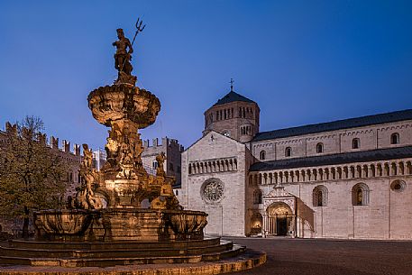 Duomo square with the Fountain of Nettuno and the Cathedral of San Vigilio in the background at twilight, Trento, Trentino Alto Adige, Italy Duomo square with the Fountain of Nettuno and the Cathedral of San Vigilio in the background at twilight, Trento, Trentino Alto Adige, Italy