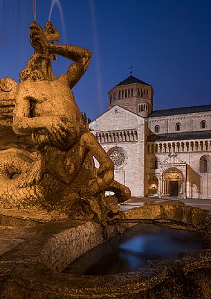 The Fountain of Nettuno and the Cathedral of San Vigilio in the background at twilight, Trento, Trentino Alto Adige, Italy The Fountain of Nettuno and the Cathedral of San Vigilio in the background at twilight, Trento, Trentino Alto Adige, Italy