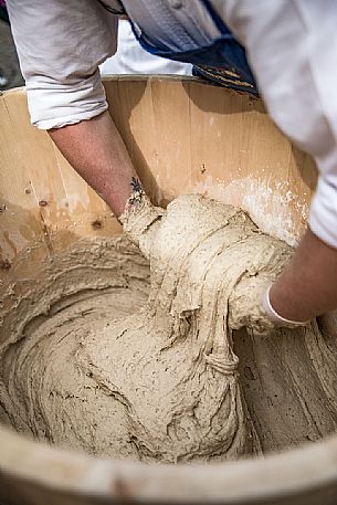 Bread preparation during the traditional bread and strudel festival in Duomo square, Bressanone, Isarco valley, Alto Adige, Italy, Europe