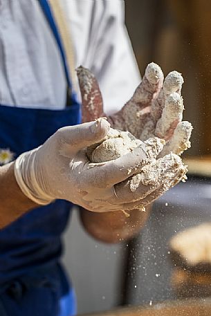 Bread preparation during the traditional bread and strudel festival in Duomo square, Bressanone, Isarco valley, Alto Adige, Italy, Europe