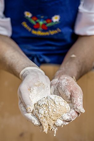 Bread preparation during the traditional bread and strudel festival in Duomo square, Bressanone, Isarco valley, Alto Adige, Italy, Europe