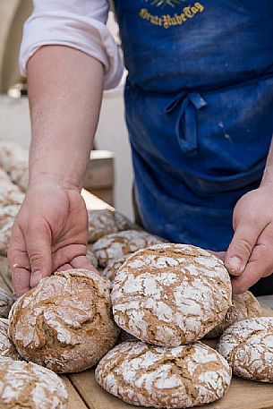 Freshly baked rye bread during the bread and strudel festival in Duomo square in Bressanone, Alto Adige, Italy, Europe Freshly baked rye bread during the bread and strudel festival in Duomo square in Bressanone, Alto Adige, Italy, Europe