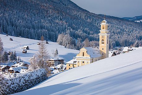 The church of Sesto' s village illuminated at the first light of morning, dolomites, Alta Pusteria valley, Trentino Alto Adige, Italy, Europe The church of Sesto' s village illuminated at the first light of morning, dolomites, Alta Pusteria valley, Trentino Alto Adige, Italy, Europe