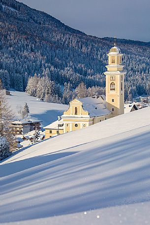 The church of Sesto' s village illuminated at the first light of morning, dolomites, Alta Pusteria valley, Trentino Alto Adige, Italy, Europe The church of Sesto' s village illuminated at the first light of morning, dolomites, Alta Pusteria valley, Trentino Alto Adige, Italy, Europe