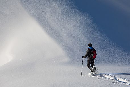 Trekker with snowshoes near Passo Falzarego, Cortina d'Ampezzo, Veneto, Italy, Europe