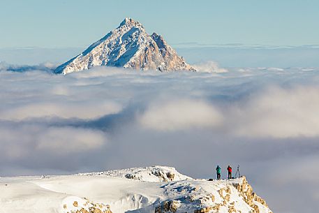 Photographers immortalise the Antelao mount rising from the sea of clouds, Cortina d'Ampezzo, dolomites, Italy, Europe