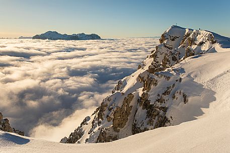 Lagazuoi peak and sea of clouds at sunset from the Lagazuoi refuge, in the background the Sella mountain range, dolomites, Italy, Europe