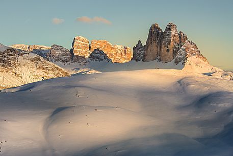 The summit cross of the Specie Mount and the Tre Cime di Lavaredo on background at sunset, Prato Piazza, Braies, Trentino Alto Adige, Italy, Europe