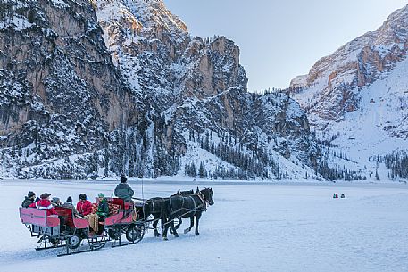 The horse carriage crosses the frozen Braies lake, Braies, Pusteria valley, Trentino Alto Adige, Italy