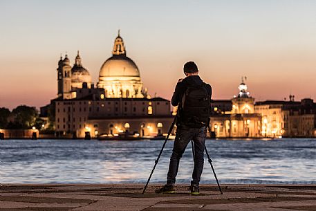 A photographer immortalizes the sunset's color from Saint Giorgio Island, Venice, Italy, Europe