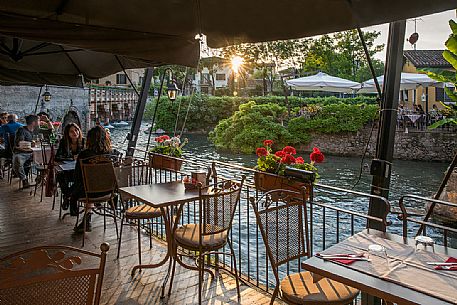 Aperitif place overlooking the river Mincio in Borghetto village, Valeggio sul Mincio, Veneto, Italy, Europe