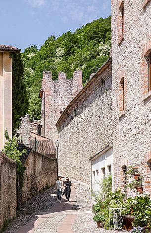 Two girls walk in the alleys around the walls of Marostica, Veneto, Italy, Europe Two girls walk in the alleys around the walls of Marostica, Veneto, Italy, Europe