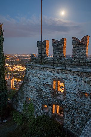 The towers of the Castello Superiore of Marostica by night and in the background the old town, Vicenza, Veneto, Italy