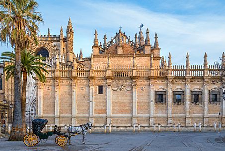Horse cart for tourists parked in front of Seville Cathedral or Church of Santa Maria della Sede, one of the largest Gothic cathedrals in the western world and a UNESCO World Heritage Site since 1987, Seville, Spain, Europe